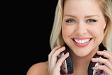 Smiling woman standing while holding her headphones