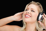Cheerful blonde woman wearing headphones