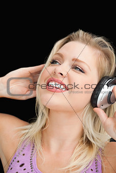 Joyful blonde woman listening to music