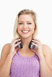 Fair-haired woman holding her headphones