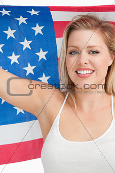 Smiling woman holding the Old Glory flag