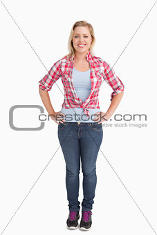 Happy young woman placing her hand on her hips