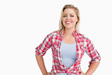 Smiling blonde woman putting her hands on her hips