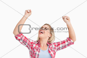 Happy woman raising her two fists