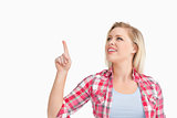 Blonde woman smiling while pointing her finger up