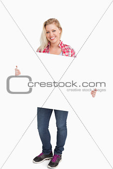 Smiling woman holding a blank placard