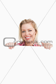 Happy woman holding a blank placard