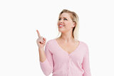 Smiling woman pointing at a blank space