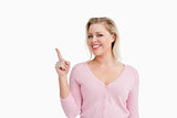 Joyful attractive woman pointing her finger up
