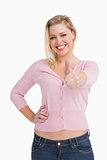 Smiling woman posing while putting her thumbs up