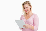 Blonde woman standing while using her touchscreen