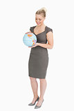 Woman looking at a globe 