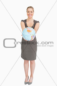 Businesswoman showing a globe 