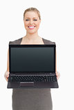 Woman standing while showing a laptop