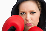 Woman protecting her face with boxing gloves