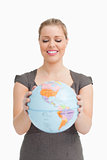 Pretty woman showing a globe 