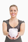 Piggy bank showing by a woman