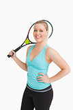 Woman smiling while holding a racquet behind her head