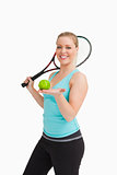 Woman showing a tennis ball in her hand