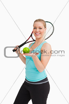 Woman showing a tennis ball in her hand