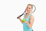 Woman smiling while showing a yellow tennis ball