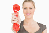 Retro red phone in a hand of woman