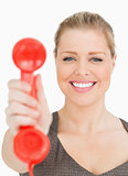 Woman smiling showing a retro phone