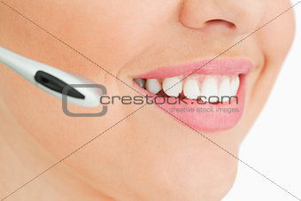 Close-up of a woman smiling working in call center