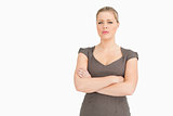 Uneasy woman standing with her arms crossed