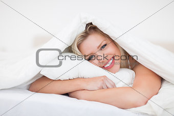 Blonde embracing her pillow 