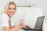 Casual woman with a credit card and a laptop