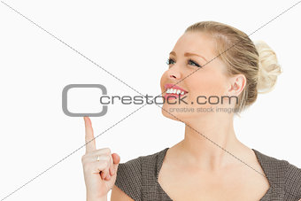 Woman pointing and looking something up
