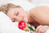 Young woman with a rose sleeping