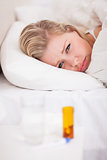 Sick young woman with medicines