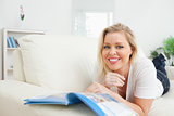 Woman smiling while reading a booklet