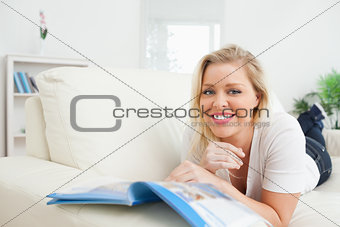 Woman smiling while reading a booklet