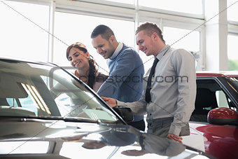 People looking at a car
