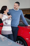 Couple standing next to a car