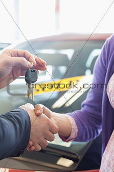 Woman shaking the hand of a man