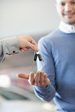 Customer receiving keys from a car dealer