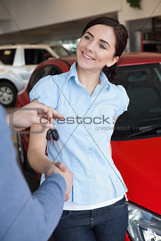 Smiling woman shaking the hand of a man