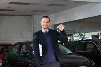 Salesman holding car keys 