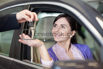 Woman smiling while sitting in a car