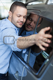 Man hugging a car