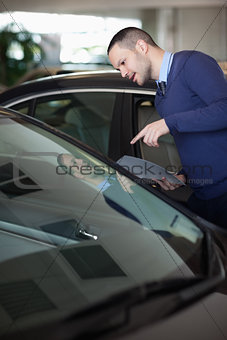 Man looking inside a car