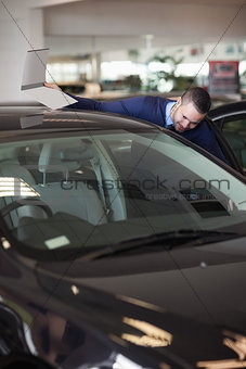 Dealer looking into a car