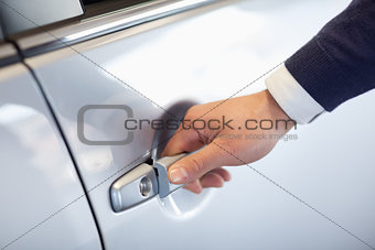Close up of a man opening a car door