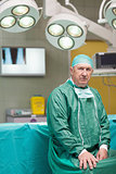Serious surgeon looking at camera