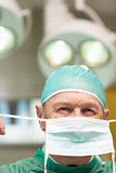 Close up of a surgeon putting on a surgical mask