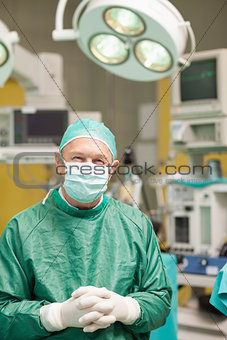 Happy surgeon crossing his hands